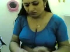 In front of a livecam, a cute and plump Indian wifey teases on the couch.